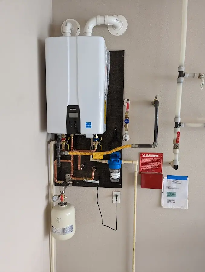 Professional plumber installing copper piping in a Eagle home